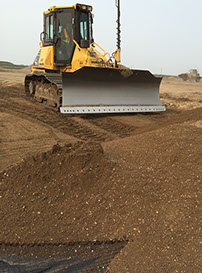 Automated doser blades gravel over geotextile cloth for road construction project&nbsp; Saskatoon Saskatchewan completed by Rite Choice Construction
